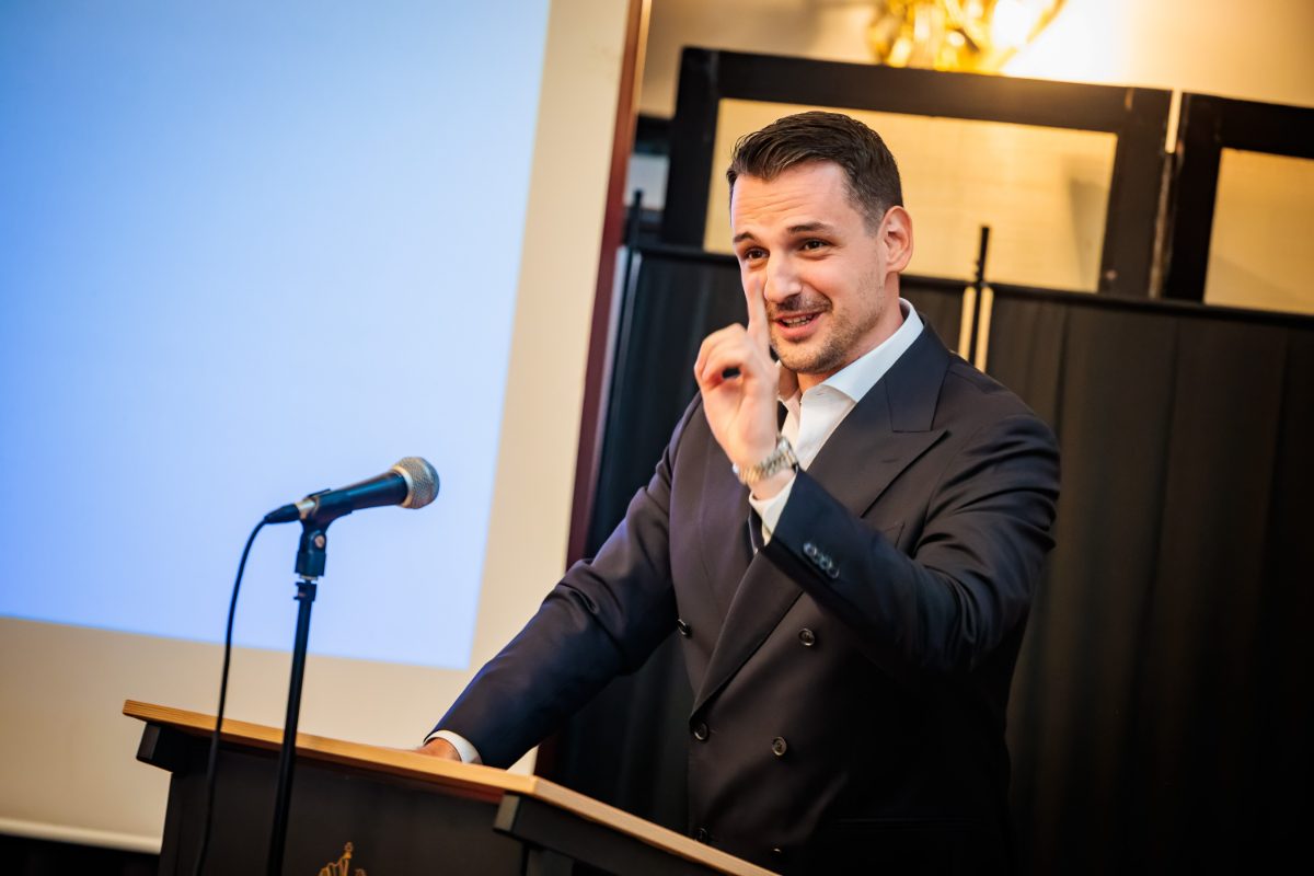 A speaker at the lectern during the iPLC plenary